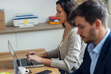 Canvas Print - Smart business people working together with laptop while talking in the coworking place.