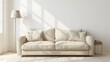 © shaiq - A beige couch sits in front of a blank white wall in a simple living room. A lamp is nearby.