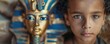 © Stanislav Kozakov - Close-up of a young Egyptian boy with a pharaoh toy