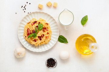 Wall Mural - Plate with tasty pasta carbonara and ingredients on white background