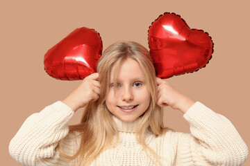 Poster - Cute little girl with heart shaped air balloons on brown background. Valentine's day celebration