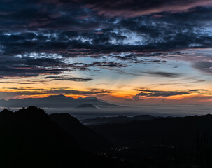 Wall Mural - Sunrise sky with silhouettes of mountains at mount bromo, java, indonesia