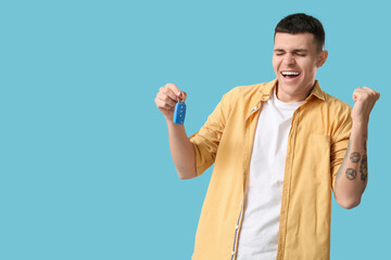 Poster - Emotional young man with car key on blue background