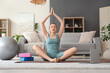 © Pixel-Shot - Sporty young woman training with yoga blocks and laptop on mat at home