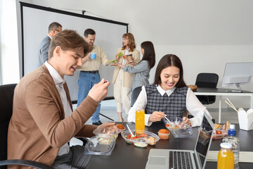Wall Mural - Business people having lunch at table in office
