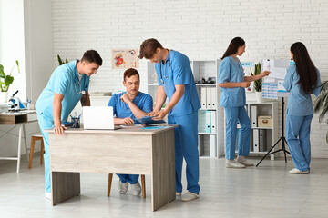 Canvas Print - Male doctors working at table in clinic