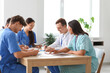 © Pixel-Shot - Young doctors working at table in clinic