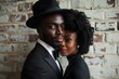 © ylivdesign - Elegant couple wearing black tie fashion posing in front of brick wall