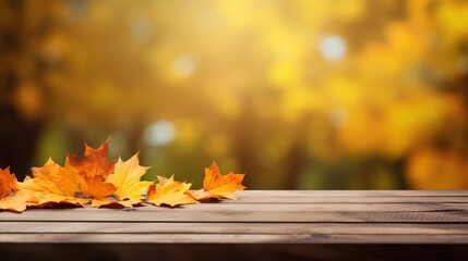 Wall Mural - Autumn Leaves on a Wooden Table with Blurry Background