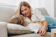 © SHOTPRIME STUDIO - Mother and daughter bonding moment on a cozy couch, sharing smiles and laughter in a warm, loving embrace