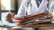© Borin - A medical insurance claims adjuster processing paperwork and documentation in an office setting.