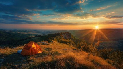 Wall Mural - A scenic campsite on a hilltop overlooking a sprawling valley bathed in the golden light of the setting sun.