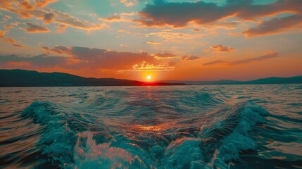 An image of a vibrant sunset over a serene lake, with waves on the water 