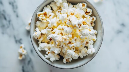 Wall Mural - A small bowl of airpopped popcorn drizzled with avocado oil and sprinkled with nutritional yeast for a guiltfree and nutrient dense snack.