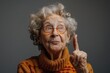 © Boomanoid - Elderly woman with glasses making peace sign