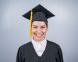 © Михаил Решетников - Smiling woman in graduation gown on white background.