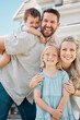 © CoetzeeRising/peopleimages.com - Portrait, family and happy in home outdoor with piggyback for day off, bonding and support with care. Parents, kids and smile for child development or growth with house or life insurance for security