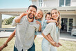 © CoetzeeRising/peopleimages.com - Portrait, piggyback and parents with children outdoor for love, bonding and playful interaction of support at house. Smile, woman and man with kids for family activity in backyard for memory at home