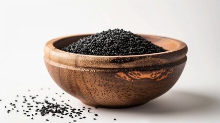 Wall Mural - Wooden bowl containing black sesame seeds against a white backdrop