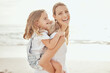 © CoetzeeRising/peopleimages.com - Happy, portrait or mother and daughter at beach for piggyback love, trust and support, laugh and bonding in nature. Travel, family and mom with kid at the ocean for back ride fun, adventure or games