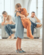 © peopleimages.com - Child, teddy and parents fighting in house, mental health and sad or depressed or parent separation or divorce. Security toy, comfort and home conflict with emotional distress, mom and dad in lounge