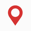 © Hogr - A red location pin icon. The pin is designed with a rounded top, resembling a location marker, and a pointed bottom, indicating direction. It is set against a white background.