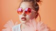 © Elmira - A closeup view of a teenage girl wearing holographic sunglasses and a white shirt, posing against an orange backdrop. Her playful expression is captured in this vibrant and stylish portrait