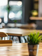 Wall Mural - Relaxation lounge, cafe area in co-working building. Closeup to empty wooden table with chairs and blurred background with barista serving organic drinks