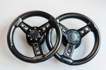 Wall Mural - Close-up of two black steering wheels sitting on a white surface, ideal for use in automotive or design-related contexts