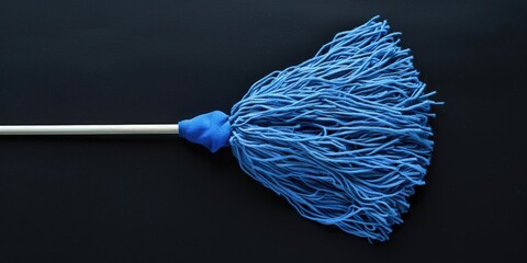 Wall Mural - A blue mop lying flat on a black surface, great for use in cleaning product promotions or as a symbol of cleanliness