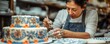 © Влада Яковенко - A baker decorating a cake with intricate designs inspired by traditional patterns from around the world.