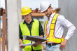 © Poguz.P - Engineer and foreman worker team inspect the construction site, Site manager and builder on construction site