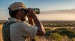 © YENI - South Africa ranger looking through binoculars in sear