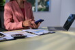 © Worapon - Image of a young Asian female company employee smiling and holding a digital tablet standing on a white background.