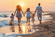 © BetterPhoto - A family of four runs along the beach at sunset, holding hands and enjoying the waves and golden sunlight.