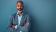 © Carmen - Portrait of handsome African-American older man with beard, wearing blue jacket, business casual and successful professional concept, copy space