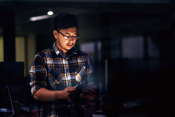 Poster - Business, night and man with tablet, typing and graphic designer with deadline, schedule and online reading. Evening, employee and consultant with tech, digital app for creative project and network