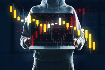 Wall Mural - Person holding a laptop with double exposure of stock market graphics on a dark background, concept of business analytics