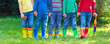 © famveldman - Kids in rain boots. Rubber boots for children.