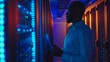 © Major - An individual meticulously inspects server racks, backlit by striking blue lighting in a high-tech server room, symbolizing technological advancement and precision.