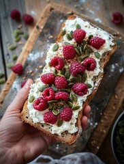 Wall Mural -  A person holding a slice of bread topped with whipped cream and raspberries