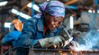 © Michal - A hard-working woman in a workshop, a black woman, a welder