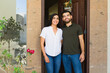 © AntonioDiaz - New Hispanic couple poses for a photo at the entrance of their new home