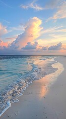 Canvas Print - A tranquil beach at sunset with gentle waves lapping against the sandy shore, under a sky painted with vibrant clouds, showcasing a soothing and picturesque coastal scene.