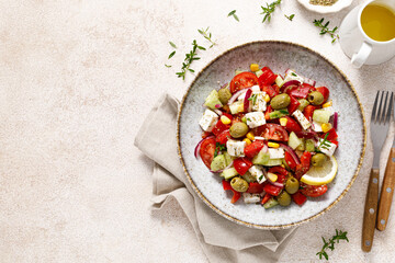 Wall Mural - Salad with feta cheese, olives and fresh vegetables, top view