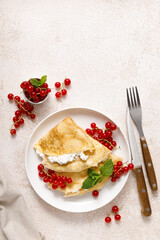 Canvas Print - Crepes or thin pancakes with cheese cottage or curd and fresh red currant berries, top view