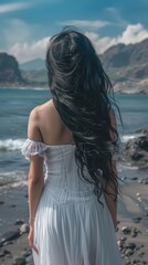 Canvas Print - a woman with long black hair standing on a beach