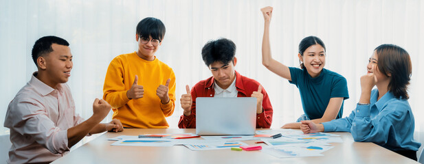 Excited and happy startup company employee celebrate after make successful strategic business marketing planning. Teamwork and positive attitude create productive and supportive workplace. Synergic