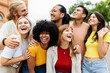 © Xavier Lorenzo - Diverse group of young friends having fun together outside. Millennial student people laughing and having fun enjoying holiday. Youth community and friendship concept.