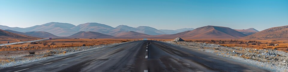 Wall Mural - Mountain landscape and asphalt highway under a clear blue sky